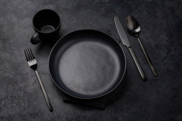 Empty plate, fork, cup, spoon and knife