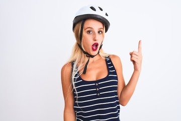 Young beautiful woman wearing bike helmet standing over isolated white background pointing finger up with successful idea. Exited and happy. Number one.