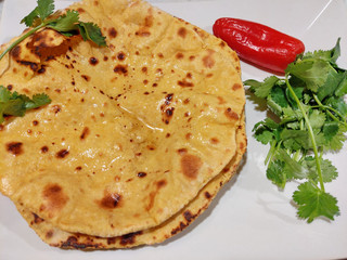 Home made Gluten free Chickpea flour Roti or Besan Roti or Chapati or bread on a plate .