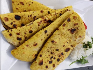 Home made Gluten free Chickpea flour Roti or Besan Roti or Chapati or bread on a plate .