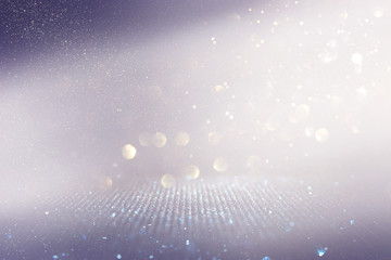 abstract background of glitter vintage lights . silver, gold and white. de-focused