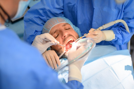 Dentist doctor performing a patient implant