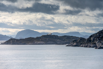 lone house on cliff in fjord, Instegeita, Norway