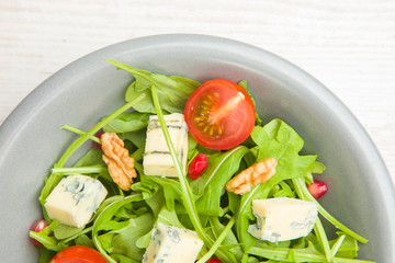 Fresh salad with tomatoes , blue cheese and nuts