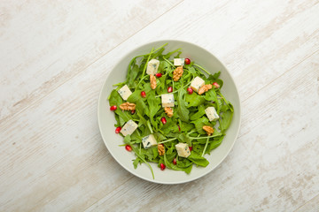 Fresh salad with tomatoes , blue cheese and nuts