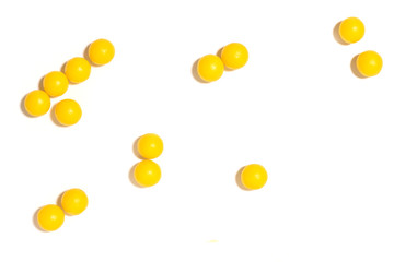 round yellow pills on a white isolated background