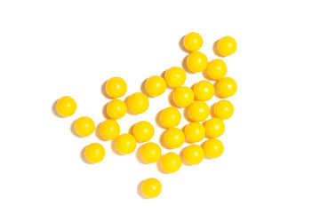 round yellow pills on a white isolated background