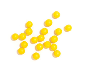 round yellow pills on a white isolated background