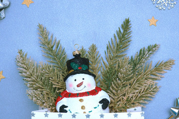 .Christmas toy snowman in a hat artificial spruce branches, Christmas tree figurine, silver....