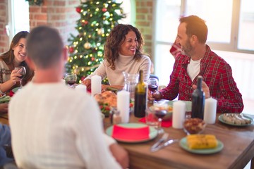 Beautiful family smiling happy and confident. Eating roasted turkey celebrating Christmas at home