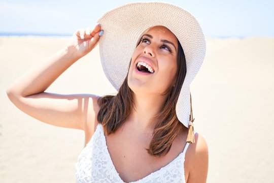 Young beautiful woman smiling happy enjoying summer vacation at maspalomas dunes beach