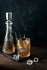 Obraz na płótnie Canvas Whiskey in glass with ice