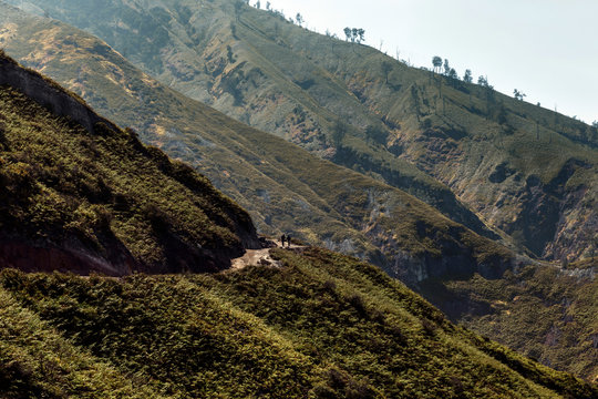 Two person walking on the road in mountain