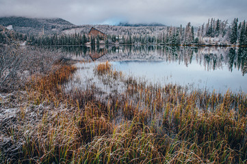 Lake in mountains between autumn and winter, original wallpaper.