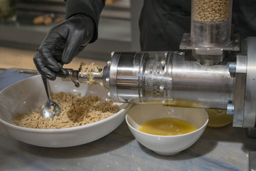 Manual cooking of traditional Siberian cedar oil.
