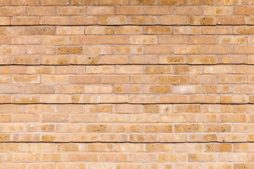 Yellow brick wall with relief lines pattern, background texture