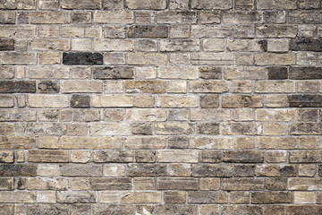 Old grungy dark gray brick wall, background texture
