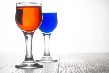Glass piles with red and blue cocktails