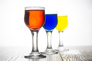 Glass piles with cocktails in red, blue and yellow