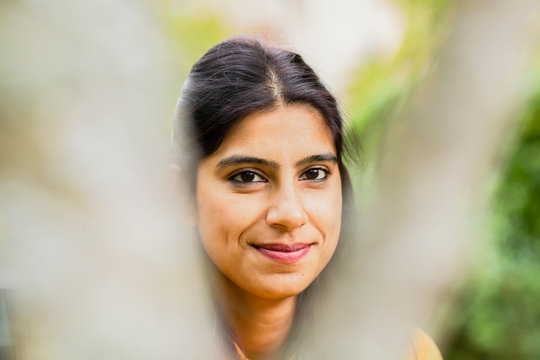 young woman outside smiling with unsharp front
