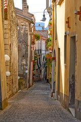 Fototapeta na wymiar Capriati in Volturno, Italy, 09/23/2017. A narrow street among the old houses of a medieval town