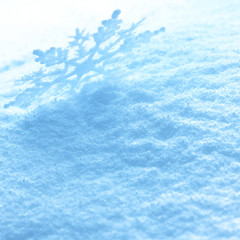 Fototapeta na wymiar Snowflakes on snow background.