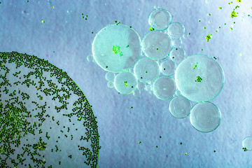 Macro shot of oil bubbles over colored background