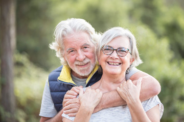 Portrait of happy and cheerful healthy caucasian old senior man and woman - elderly people together...