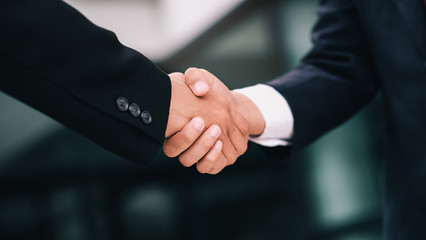 Businessmans handshake after good deal.