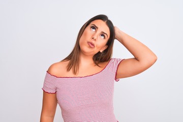 Fototapeta premium portrait of young woman looking thoughtful, thinking about a question looking up and touching head