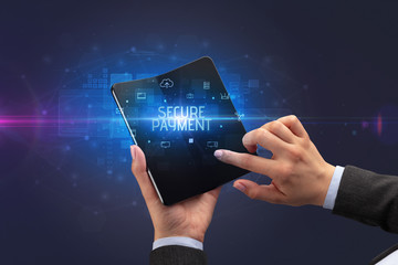 Businessman holding a foldable smartphone with SECURE PAYMENT inscription, cyber security concept