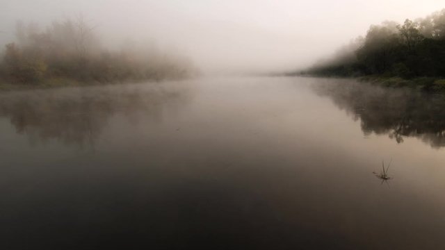 The remain of the reef of the ancient sea, composed of limestone - shikhan Kushtau. Fog on the Belaya river. Aerial view.
