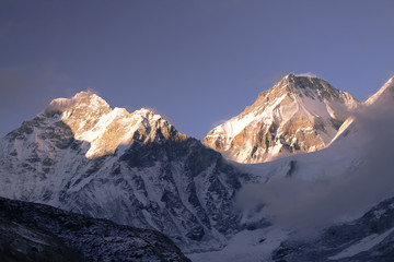 View of Khumbutse and Changtse mountain peaks from Gorak Shep (or Gorakshep) village at sunset. The summit of the mountain Khumbutse is right on the border between China and Nepal.