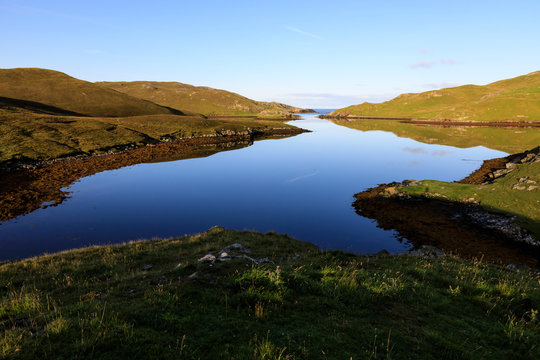 Mavis Grind, early morning reflections, narrow isthmus between North Sea and Atlantic Ocean, Shetland Isles, Scotland