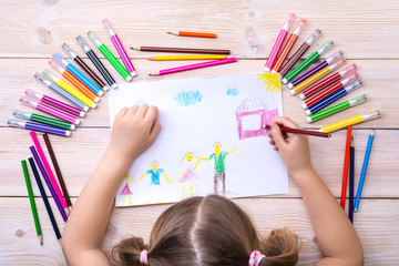 A child draws a birthday card with his family. Drawing made by a child with colorful felt-tip pens...