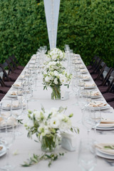 Table setting with sparkling wineglasses and cutlery in tent outdoors, copy space. Place setting at wedding reception. Table served for wedding banquet in restaurant