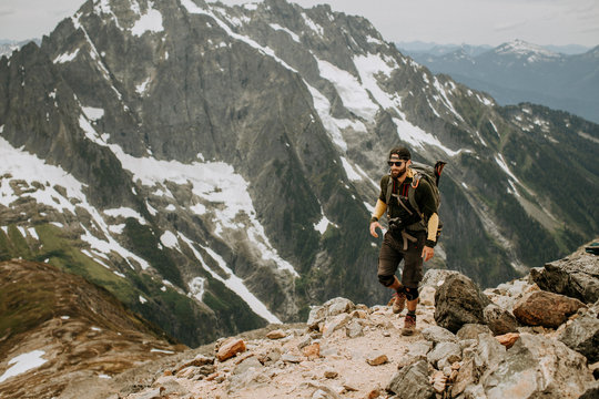 A male hiker walks along a trail in the North Cascades, Washington