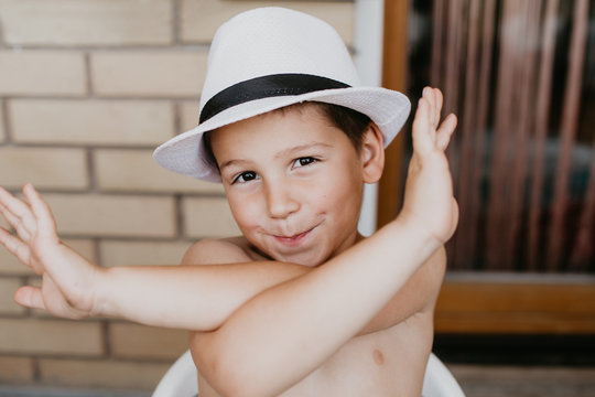 Adorable little boy in a white hat