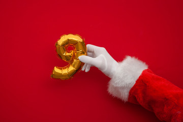 12 days of christmas. Santa hands holding 9th day balloon on red background