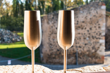 Two metal cups to toast with champagne in a romantic place