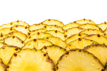 Pineapple juicy yellow slices background. Top view.