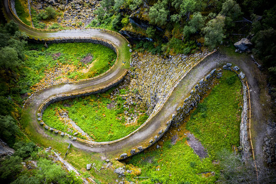Aerial view of man lying down along the bends of historic Vindhellavegen road, Borgund, Laerdal, Sogn og Fjordane county