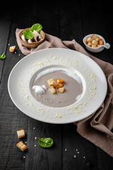 Obraz na płótnie Canvas Cream of porcini mushroom soup. Liquid gourmet meal. Restaurant menu. Background black boards.