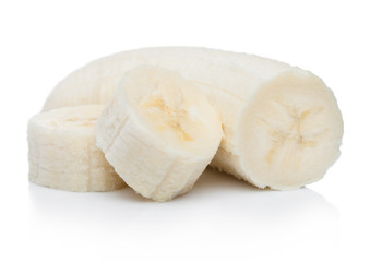 Fresh ripe organic banana sliced pieces on white background with reflection.