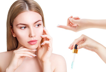Hands applying cosmetics oil and cream on beautiful woman face.