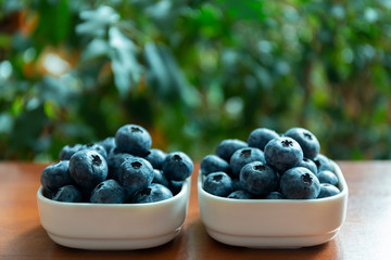 Blueberries lie on the table in portion boxes of birch bark. Delicious and healthy food contains a lot of vitamins. Russia.