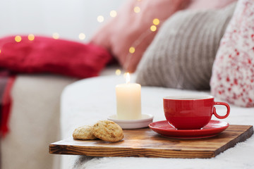 cup of tea with burning candles at home