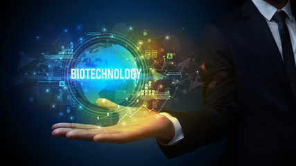 Elegant hand holding BIOTECHNOLOGY inscription, digital technology concept