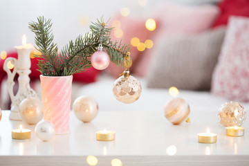 Christmas decorations with burning candles in pink and gold colors