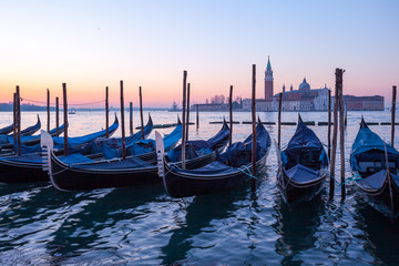 Fototapeta premium Sunrise at Venice with gondola and island of st george view from the square San marco